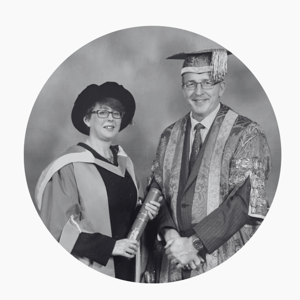 2 people in academic gowns - in black and white